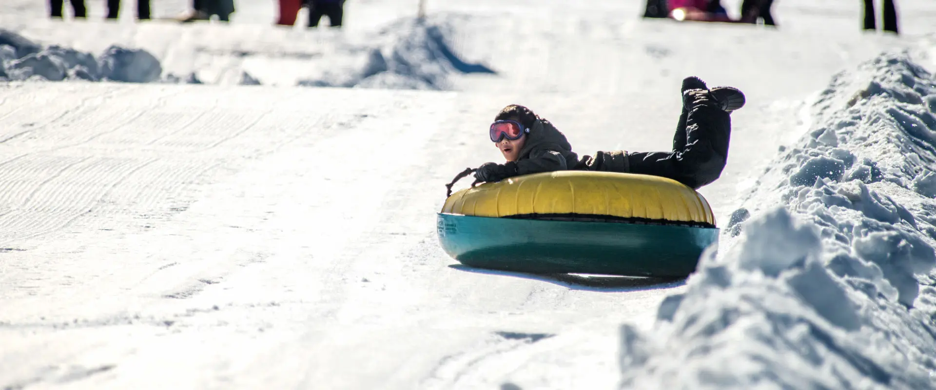 Boy riding down a tubing lane at Soda Springs