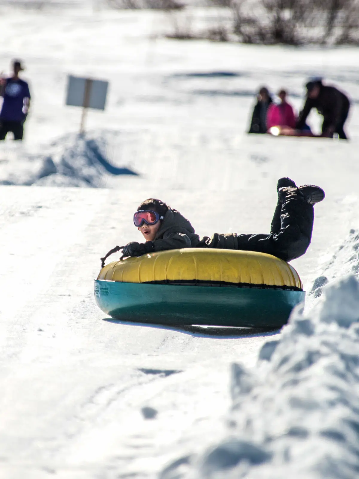 Boy riding down the tubing lane at Soda Springs